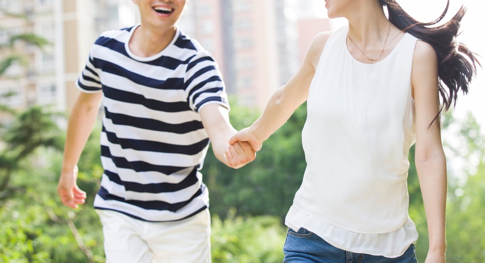 Happy young couple holding hands